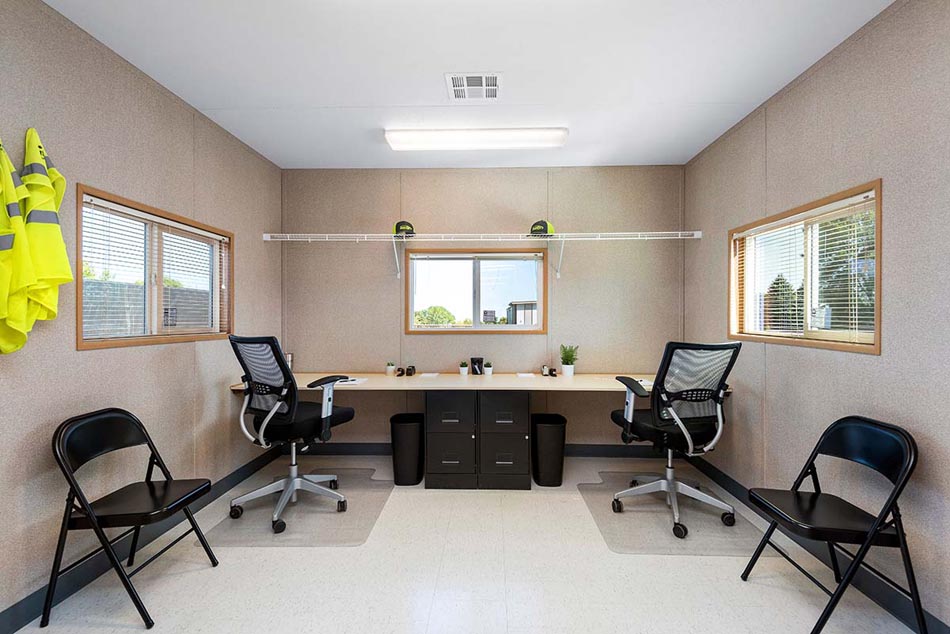 Mock-up of a mobile trailer office workspace with basic furnishings.