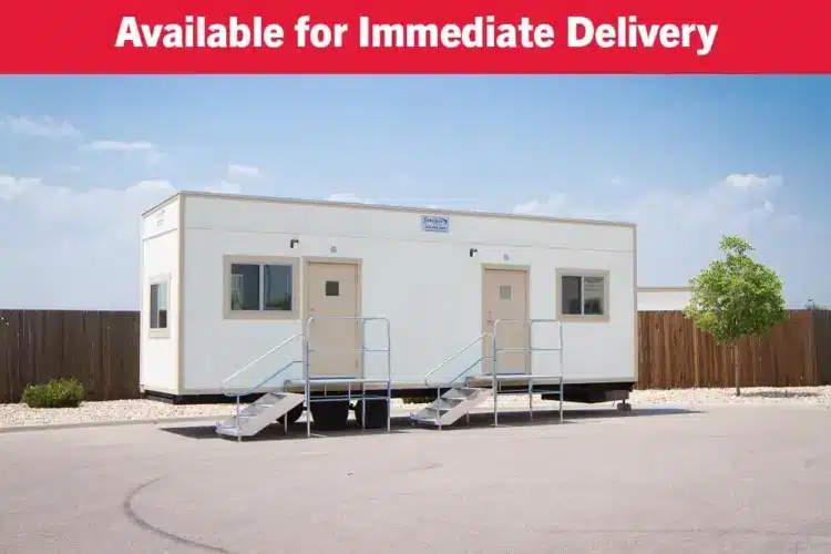 Front view of an 8x24 mobile office with steps leading up to a single door. 